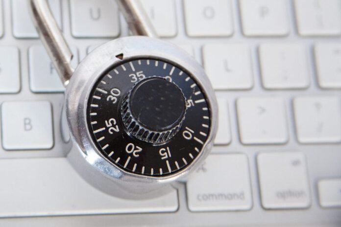 Combination padlock resting on a computer keyboard
