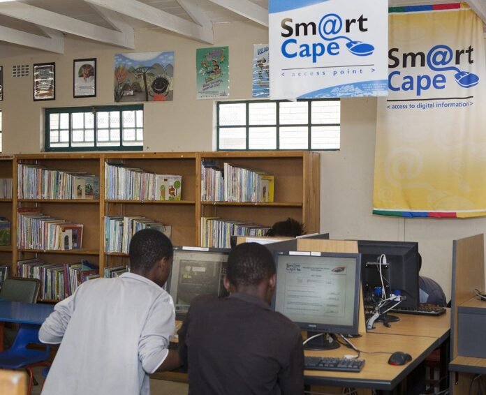 Young people using computers in a community library in Cape Town
