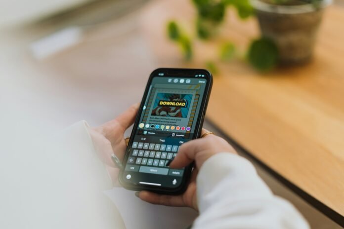 Hands holding a smartphone with a download prompt on screen