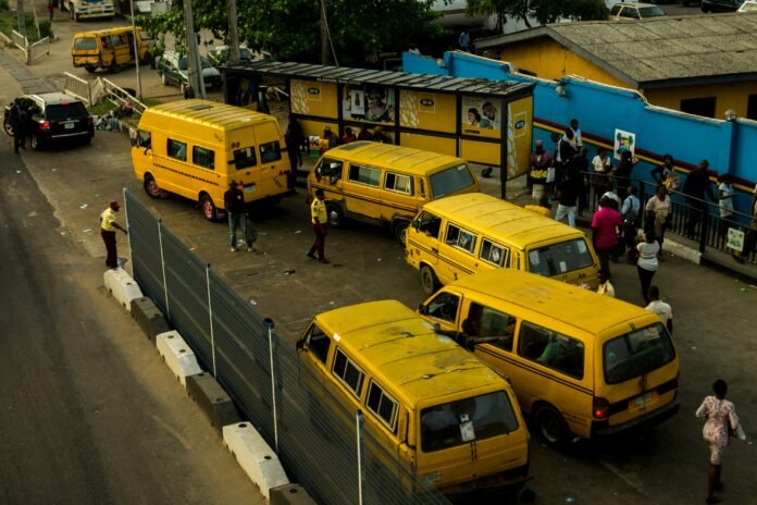 Yellow danfo buses parked at a roadside bus stop in Alapere, Lagos