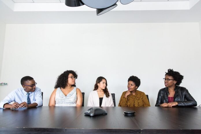 Team of tech professionals seated at a conference table