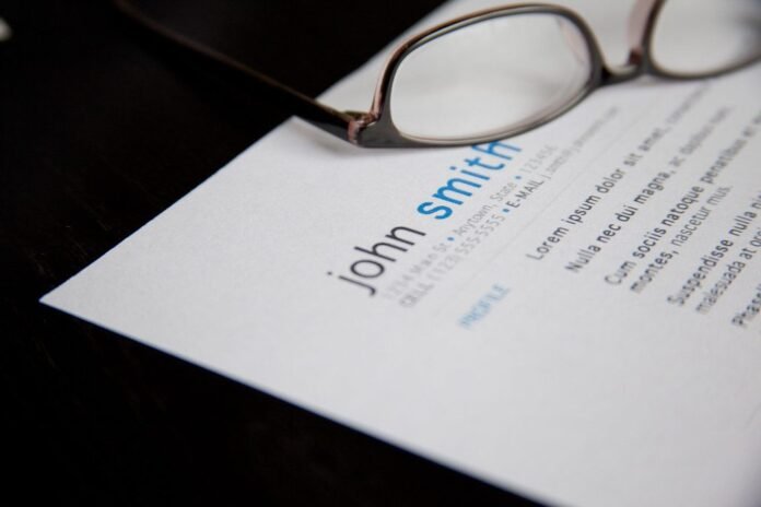 Printed CV with a pair of glasses resting on top