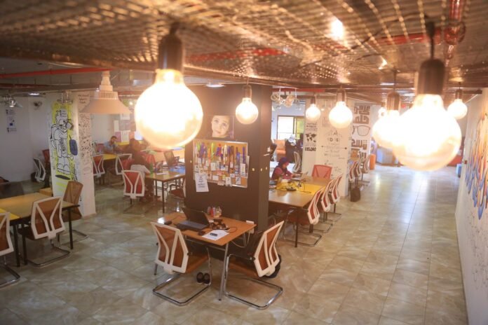 Coworking space at a tech hub with desks and hanging lights